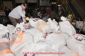 Wednesday February 15, 2012.  Iditarod volunteers unload some of Kelly Maximer's 