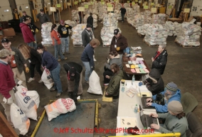 Wednesday February 15, 2012.  Iditarod volunteers for an assembly line as they prepare musher's 