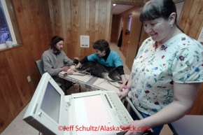 Head Vet Tech, Jan Bullock, performs an ECG heart monitoring test on Musher Nicholas Petit dog 