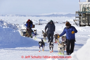 Karin Hendrickoson is helped out of the Shaktoolik checkpoint on Monday March 11, 2013.Iditarod Sled Dog Race 2013Photo by Jeff Schultz copyright 2013 DO NOT REPRODUCE WITHOUT PERMISSION