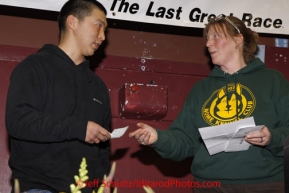 Sunday March 18, 2012   Mike Williams Jr. recieves the Nome Kennel Club "Fastest time from Saftey to Nome" award from Kirsten Bey at the musher's finisher banquet in Nome after Iditarod 2012.