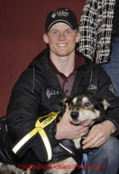 Sunday March 18, 2012   Dallas Seavey poses with his lead dog "Guiness" who was the recipient of the Lolly Medley Golden Harness awardat the musher's finisher banquet in Nome after Iditarod 2012.