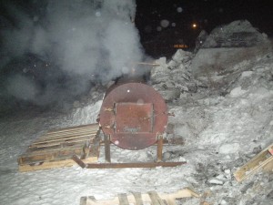 produced yesterday by junior Larry Johnson , this extraordinary device heats a 55 gallon drum of hot water for the mushers